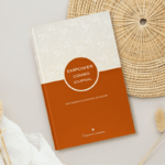 The front cover of our Empower Combo empowerment journal displayed on a round woven mat.