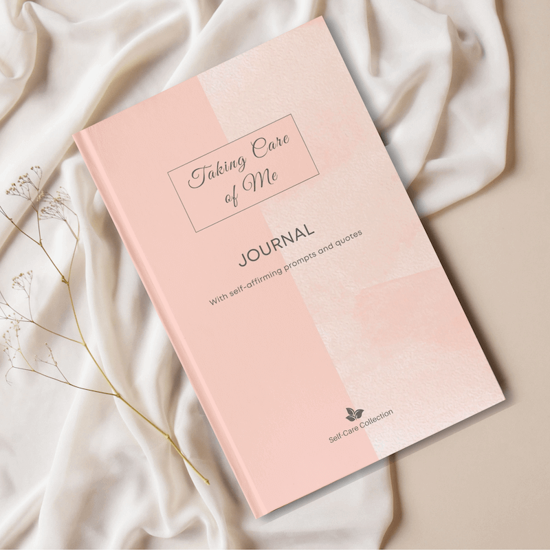 The front cover of the Taking Care of Me self-care-themed journal displayed on a white fabric background.